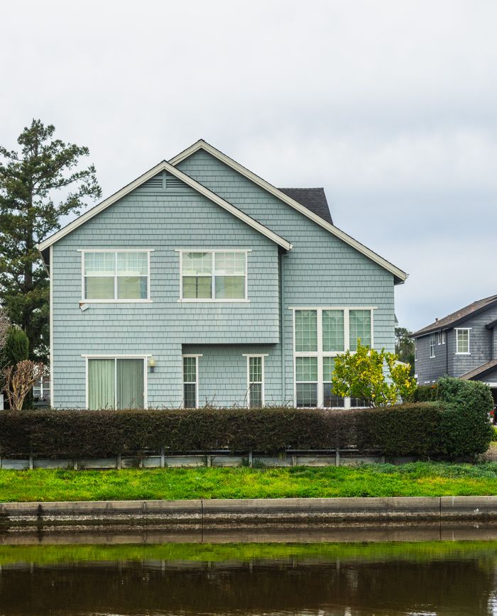 home-services-004 A contemporary detached house in a suburban neighborhood with a scenic canal front.