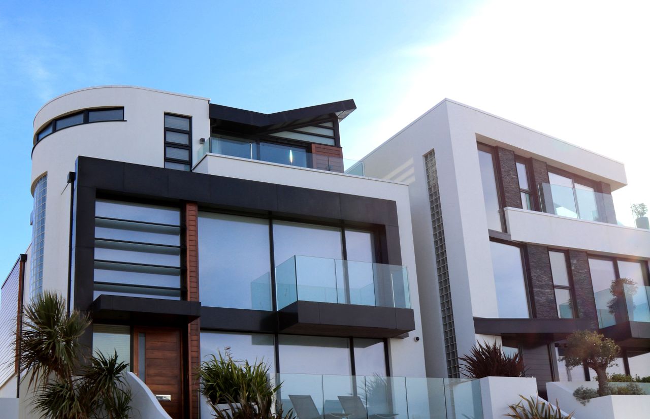 home-services-01 Contemporary luxury home with glass balconies in Poole, UK, showcasing modern architectural design.